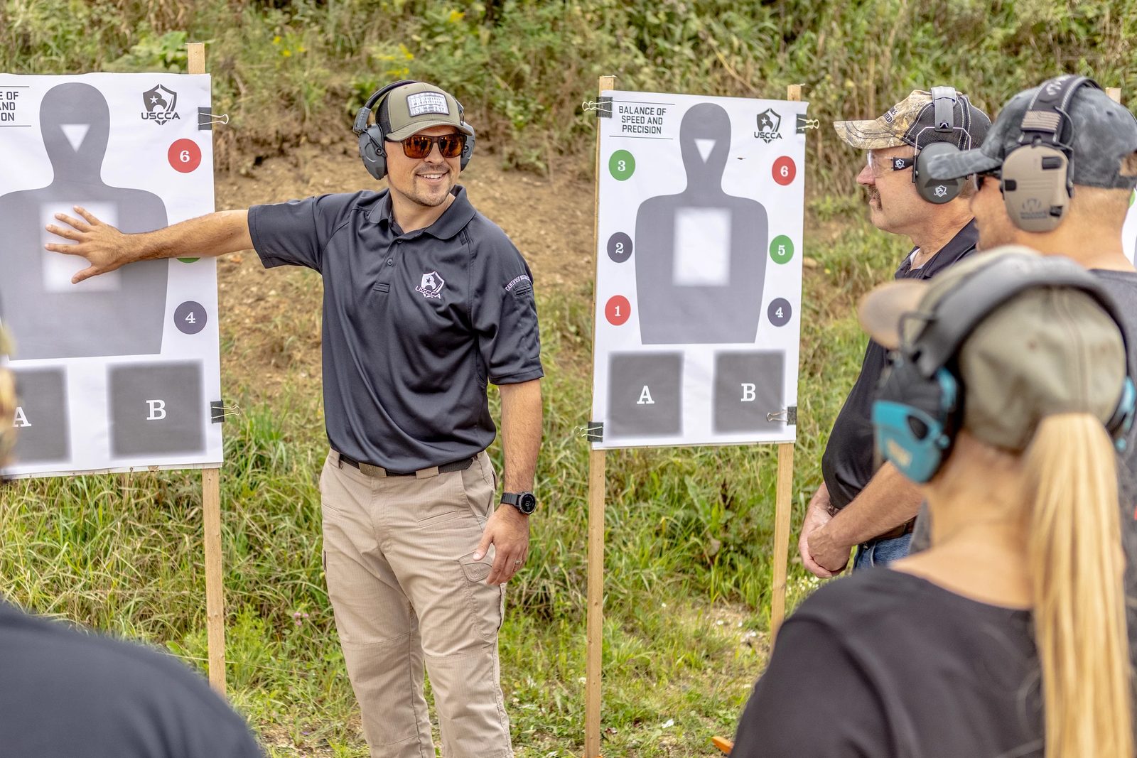 A USCCA Certified Instructor teaching a firearms class at the range