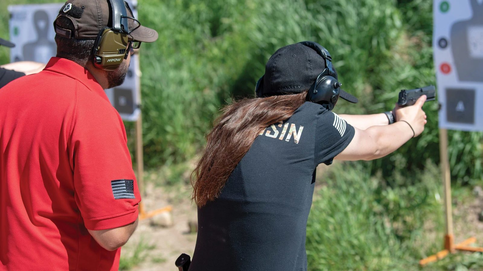 A woman training on the range with one-on-one handgun instruction